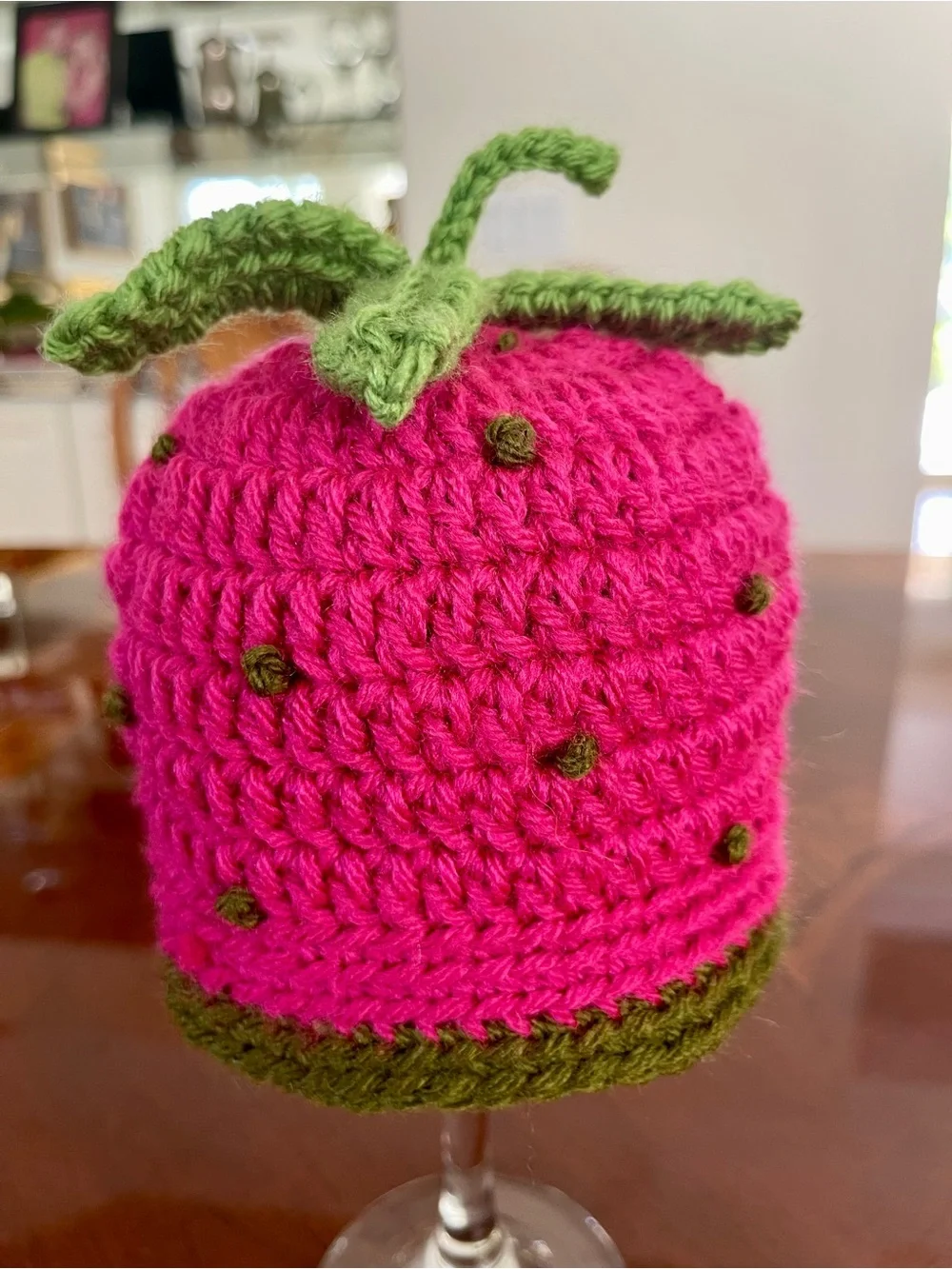 Raspberry Crochet Baby Hat with Green Leaf Accent